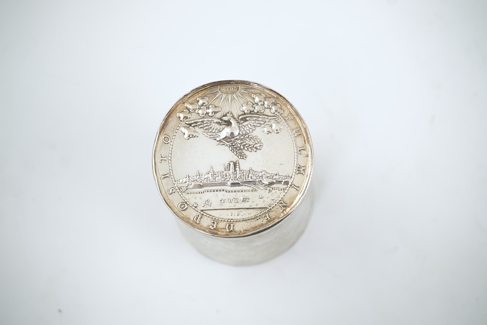 A white metal beaker the base inset with a silver medal commemorating the Peace of Oliva, 1660, Obv. Bird's-eye view of the city of Danzig with troops moving in foreground; above, an eagle crowned, an olive branch in its